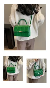Green quilted crossbody bag detail, featuring geometric stitching, top handle and gold clasp.