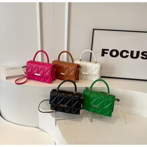 Detailed view of fashionable quilted small square shoulder bags in multiple vibrant colors.