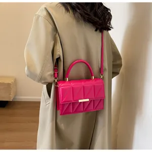 Pink quilted crossbody bag with top handle and strap for women stylish detail view.