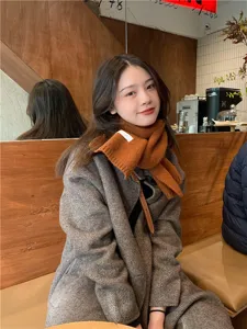Cozy winter knit scarf for women and men, stylish solid color casual neck warmer accessory.