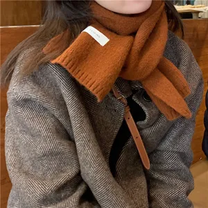 Cozy brown knit scarf detail view, warm winter neckwear with stylish woven texture.