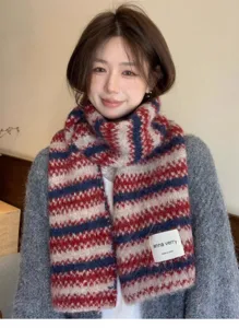 Knit scarf detail showcasing the soft striped texture, cozy winter wear close-up shot.
