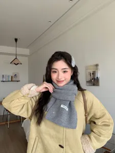 Grey knitted scarf for women, cozy winter neck warmer, soft wool blend fashion accessory.