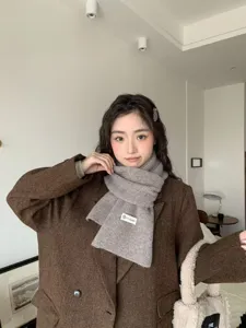 Cozy winter knit scarf for women, thick warm gray neck warmer, stylish casual cold weather wear.