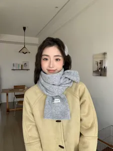 Cozy grey knitted winter scarf for women, thick and warm neck warmer for cold weather.