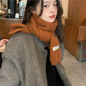 Cozy caramel knitted winter scarf detail, soft warm casual neckwear for cold weather.