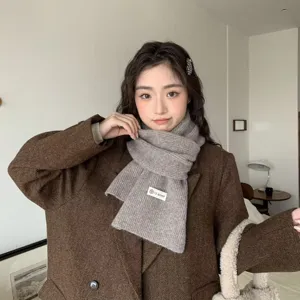 Cozy knitted winter scarf for women, soft grey neck warmer and warm fashion accessory.