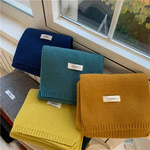 Close-up detail of soft winter knitted scarf in vibrant colors, warm daily neck accessory.
