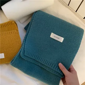 Winter solid color knitted scarf for women and men, warm and soft fabric design accessory.