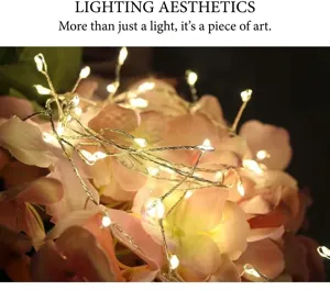 Close-up of warm white LED copper wire fairy lights wrapped around pink hydrangeas