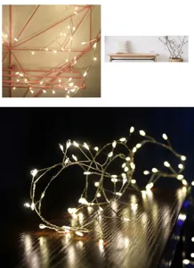 Close-up of warm white LED copper wire fairy lights on dark wooden table