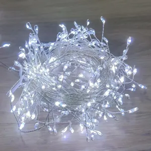 Bright LED fairy string lights coiled on a wooden surface