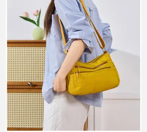Casual multi-pocket nylon crossbody bag for women, daily shoulder bag with zippered compartments.