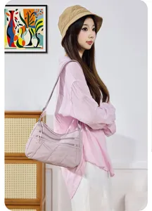 Detailed close-up view of the stylish multi-pocket washed nylon crossbody shoulder bag.