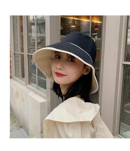 Vue détaillée d'une femme asiatique portant un chapeau bob à large bord stylé dehors.