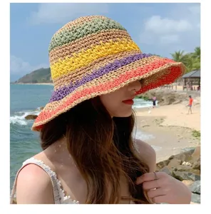 Detail shot of a colorful striped raffia sun hat, perfect beach vacation accessory for women.