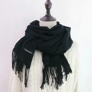 Classic solid black cashmere feel winter scarf with elegant fringe for warm daily wear.