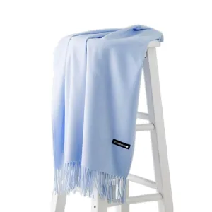 Light blue solid color winter thick long imitation cashmere scarf displayed on a white stool