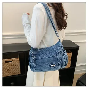 Detailed view of casual retro denim crossbody bag with multi-pocket design and shoulder strap.
