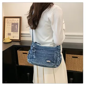 Detailed view of the stylish retro denim cross-body shoulder bag with multi pockets.