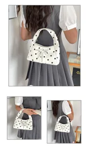 White polka dot shoulder bag with bow and chain strap for women, vintage style.