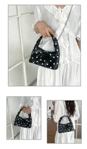 Stylish black and white polka dot underarm bag with cute bow and chic chain strap for daily wear.
