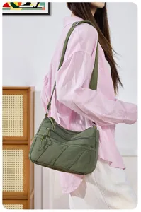 Washed nylon crossbody bag for women, multi-pocket casual shoulder bag with wide strap detail.