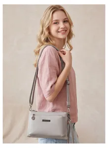 Grey PU leather crossbody bag multi-compartment detail shot showing refined metal hardware.