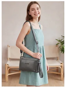 Grey PU shoulder bag with multi-compartments and handle, stylish crossbody bag for women.