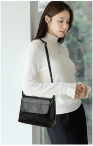 Detailed view of the women soft leather cross-body shoulder bag in classic black tone.