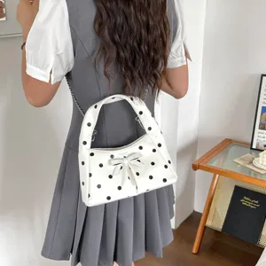 Retro polka dot shoulder bag for women, chic bowknot crossbody chain handbag in white and black.