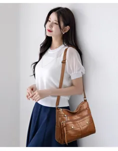 Stylish women soft PU leather shoulder bag with multiple compartments and pockets for casual use.