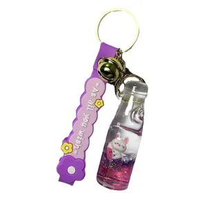 Cute liquid glitter rabbit soda bottle keychain with purple strap and bell charm for bags.