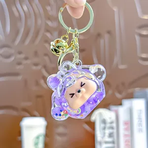 Leuke paarse acryl kiki drijfzand sleutelhanger met mooie belletje en gouden ring.