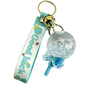 Cute liquid floating lollipop keychain with strap, perfect for car keys and backpacks.
