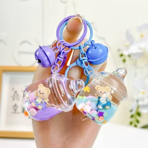 Cute liquid-filled bear baby bottle keychain, stylish cartoon bag charm and car key accessory.