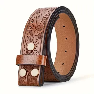 Detailed close-up of brown embossed leather belt strap with vintage carved floral pattern style.