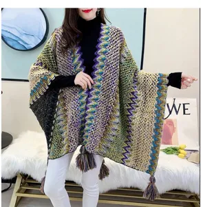 Ethnic color-blocked knitted shawl cape womens thickened outerwear with tassels.