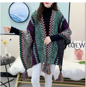 Ethnic color-block knitted cape shawl for women, cozy winter outerwear with fringe details.