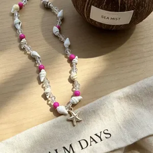 Detailed shot of a beach-style necklace with natural shells and a starfish pendant