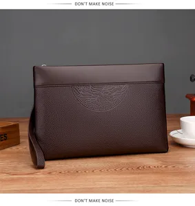 Men's dark brown leather clutch bag detail, embossed pattern and wrist strap design.