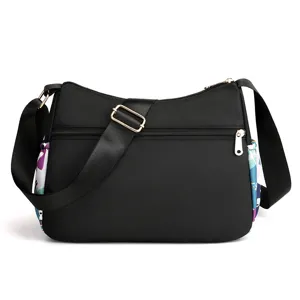 Casual nylon crossbody bag for women with multi-layer zippers and colorful side printed design.