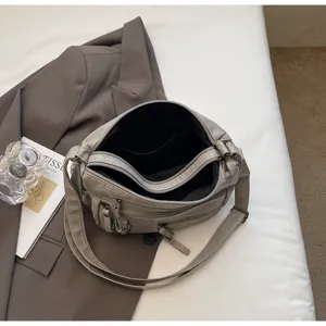 Vrouwen vintage zachte lederen crossbody tas met meerdere zakken en verstelbare riem.