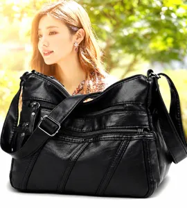 Black soft leather shoulder bag with multi zippers and adjustable strap for women.