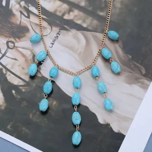 Close-up of vintage turquoise oval stone pendants on a gold chain necklace for women