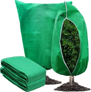 Detailed view of green plant freeze protection cover with zipper and breathable non-woven fabric.