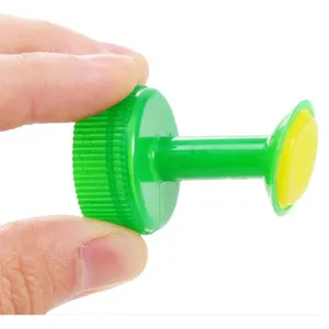 Plastic bottle cap watering sprinkler head for potted plants, garden irrigation tool.