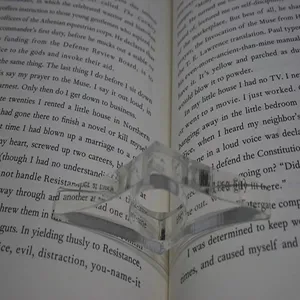 Clear acrylic thumb book page holder for comfortable reading, portable book page spreader tool.