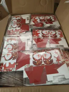 Detailed view of red Christmas pull money box kits, bulk packaged for party decorations.