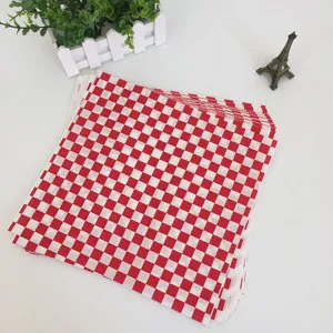 Red and white checkered greaseproof paper sheets for burgers, French fries, and pizza.